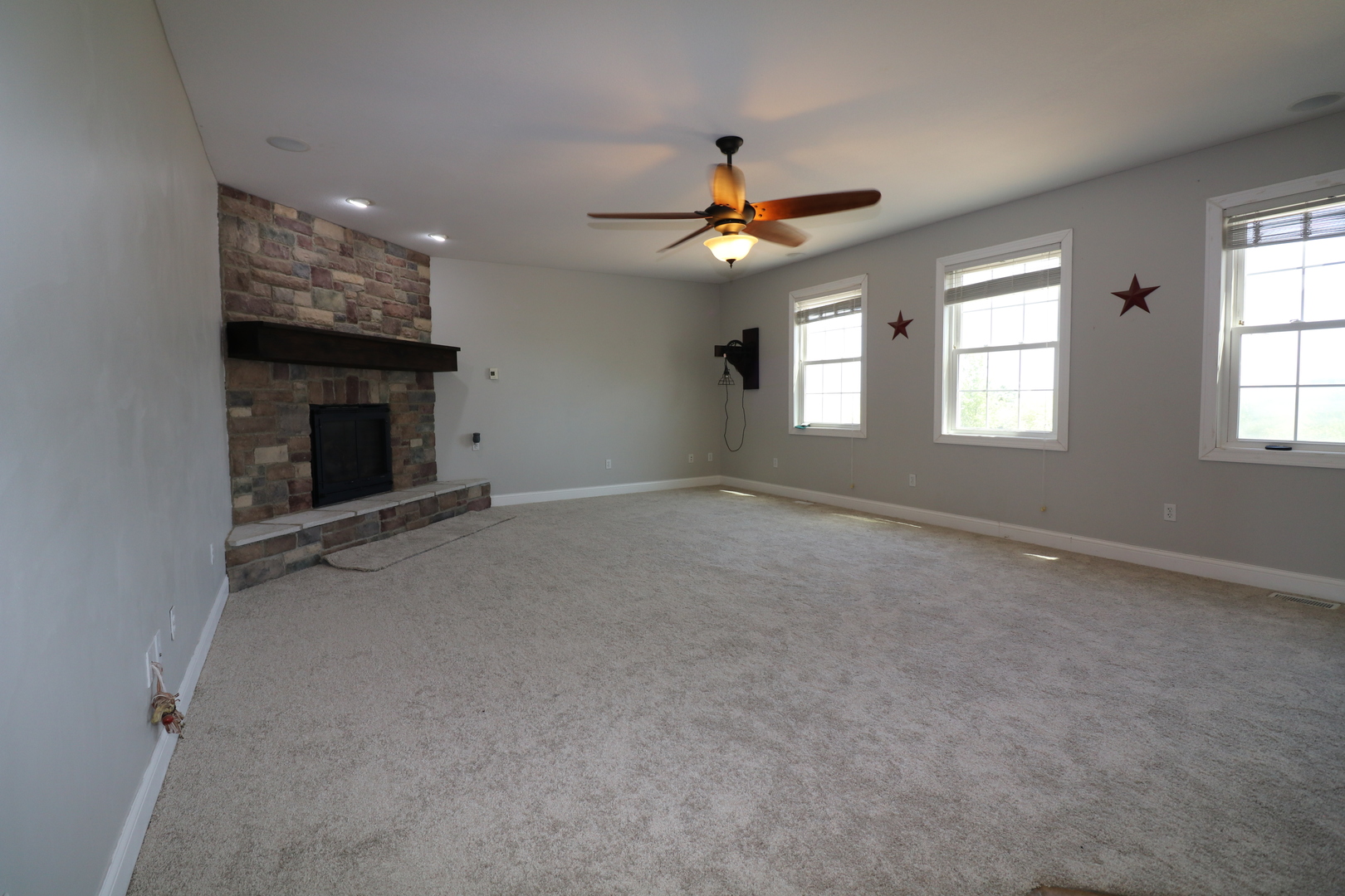 9358 Little Galilee Road Clinton, IL 61727 - Photo 14 of 40 an empty room with windows and fan