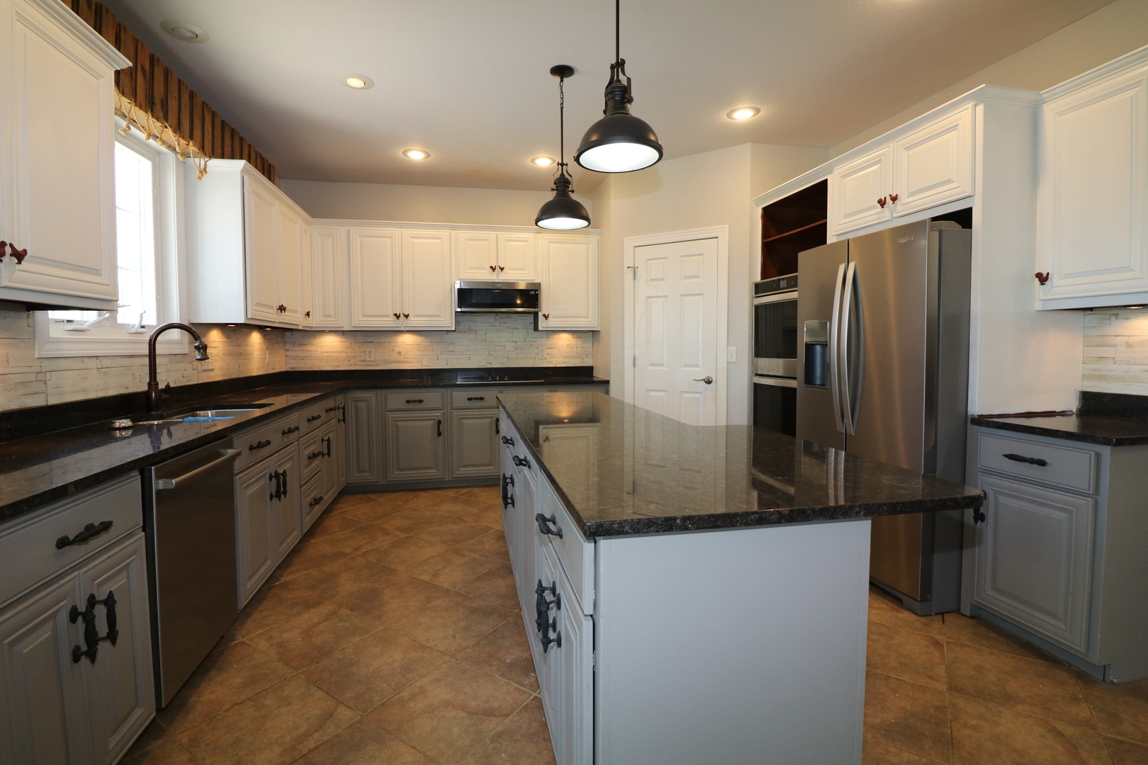 9358 Little Galilee Road Clinton, IL 61727 - Photo 17 of 40 a kitchen with stainless steel appliances granite countertop counter space a sink and a refrigerator