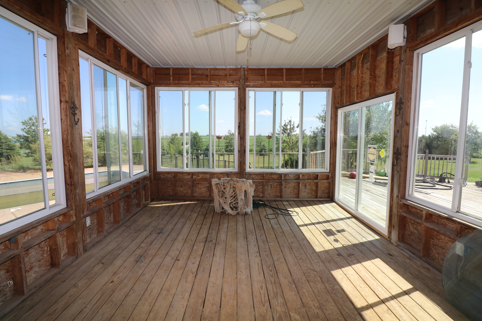 9358 Little Galilee Road Clinton, IL 61727 - Photo 22 of 40 a living room with hardwood floor and large windows