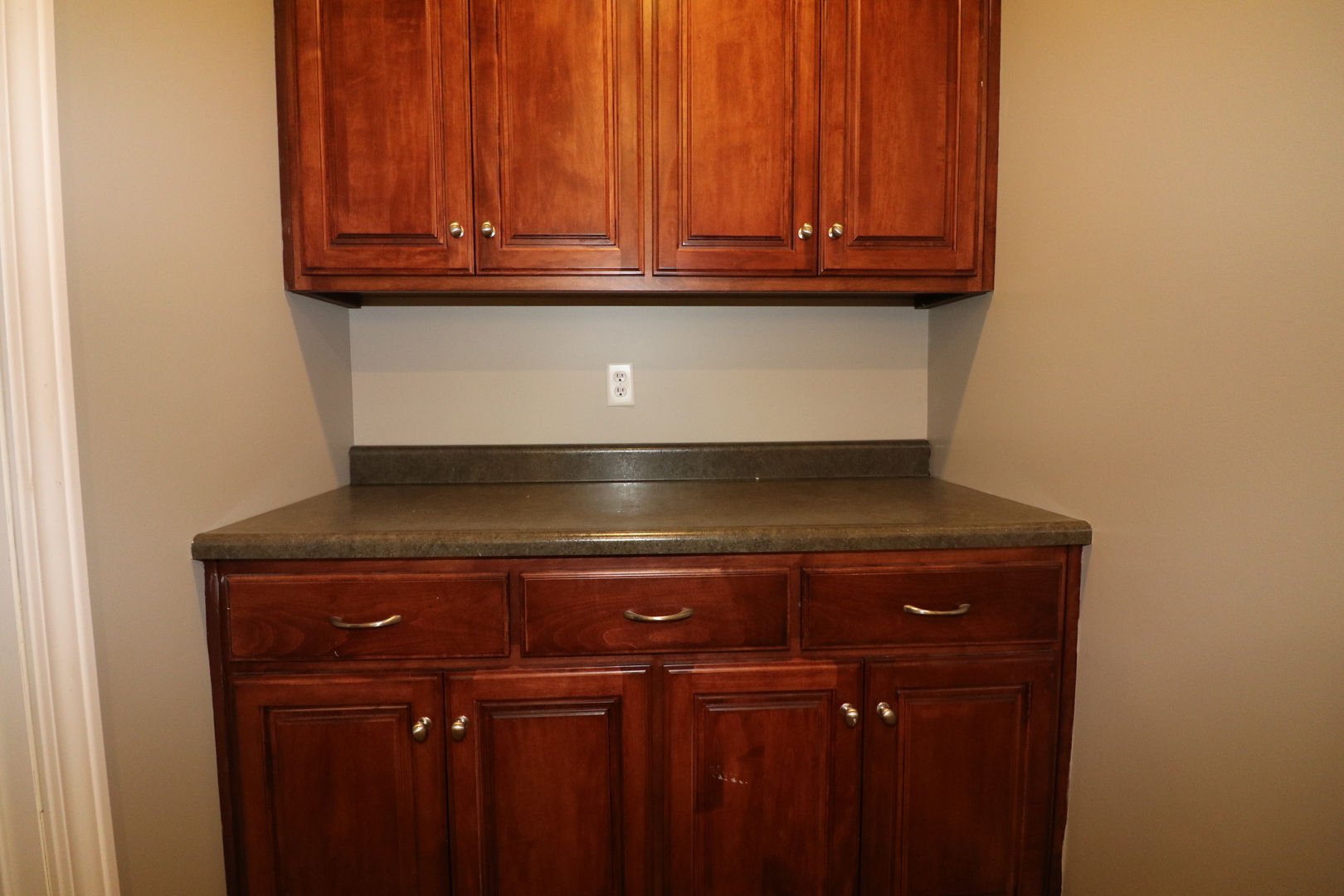9358 Little Galilee Road Clinton, IL 61727 - Photo 33 of 40 a view of oven with granite countertop wooden cabinets