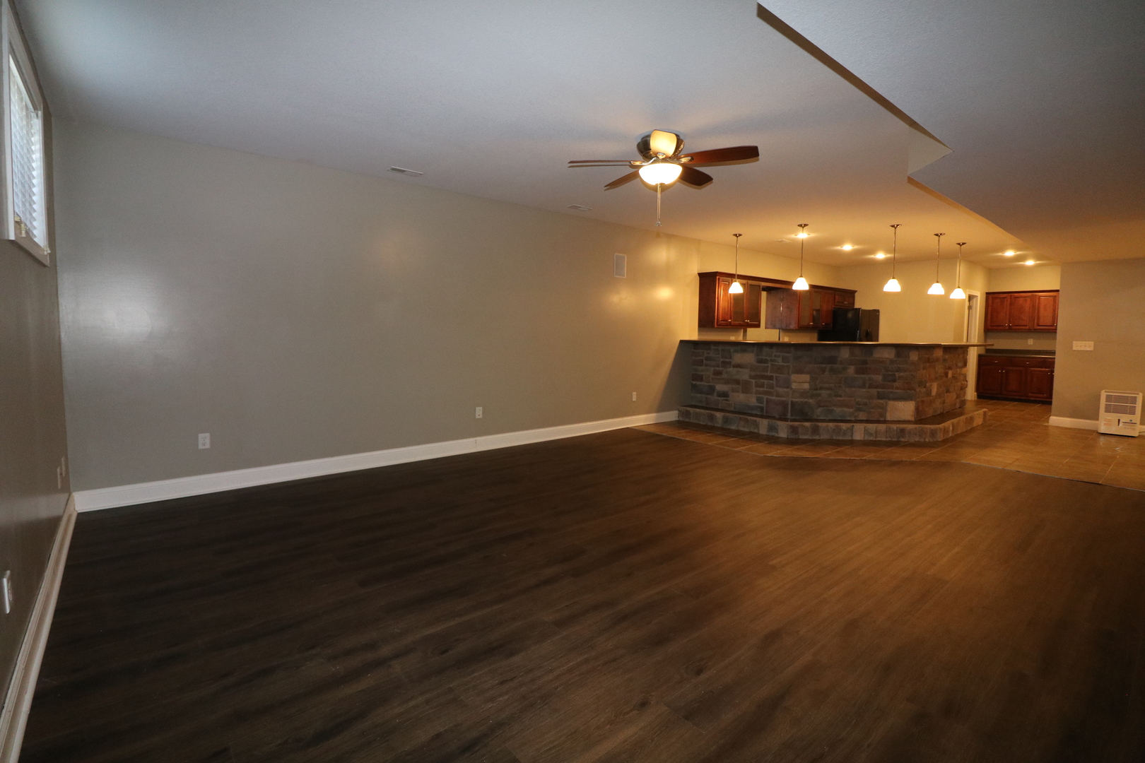 9358 Little Galilee Road Clinton, IL 61727 - Photo 37 of 40 an empty room with wooden floor and fan