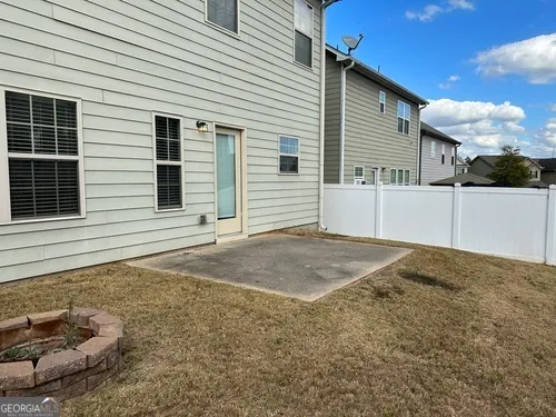 a view of a house with a backyard