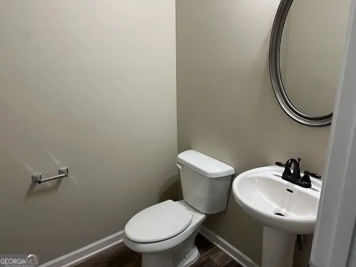 a white toilet sitting next to a bathroom sink