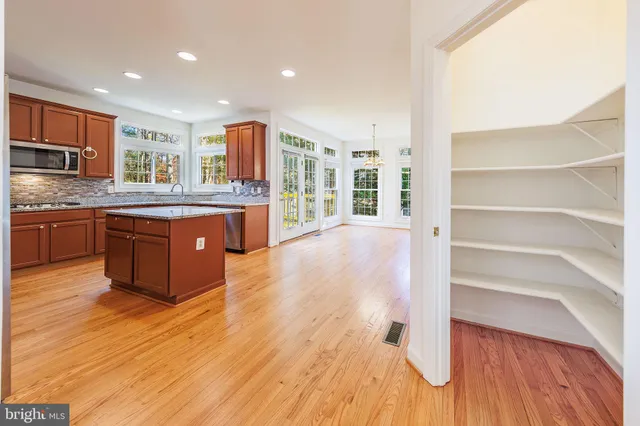 an aerial view of residential house with outdoor space and trees all around