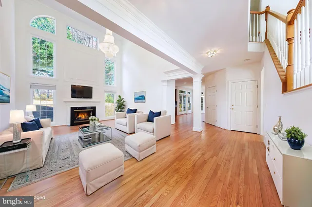 a living room with fireplace furniture and a large window