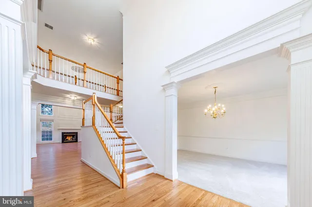 an empty room with kitchen view and windows