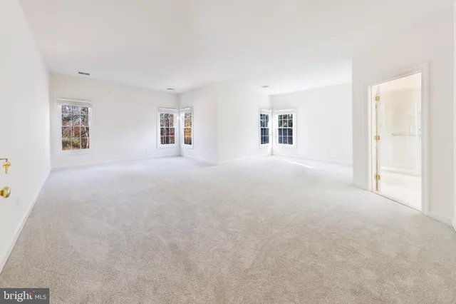 a spacious en suite bathroom with a double vanity sink mirror and