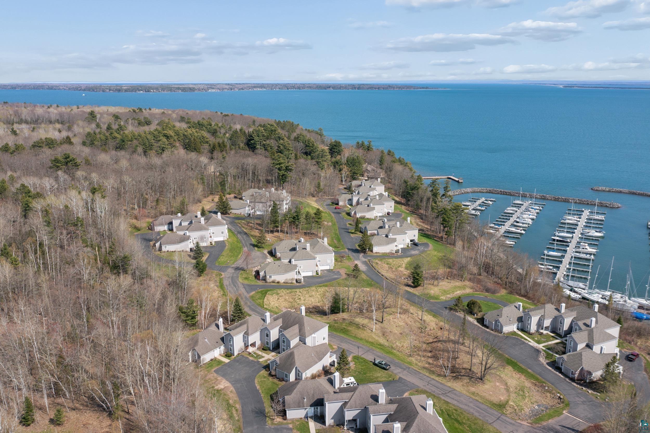 34590 Bay View Road, Unit 801 Bayfield, WI 54814 - Photo 30 of 36 Aerial perspective showcasing multiple properties situated on a wooded hillside