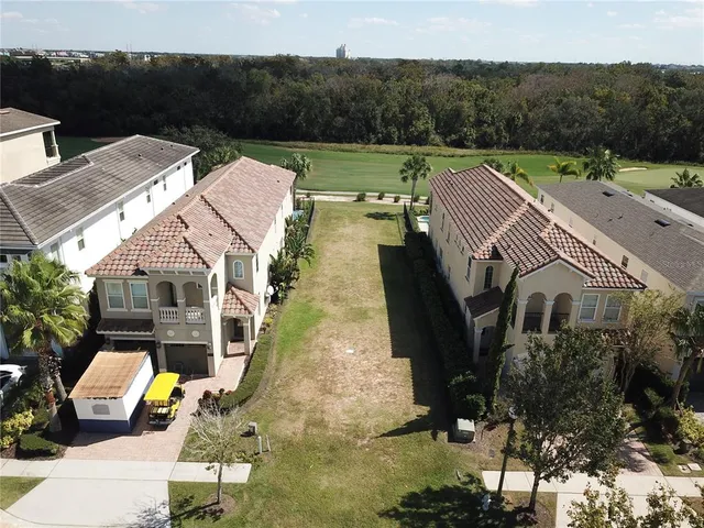 an aerial view of a house with garden space and street view