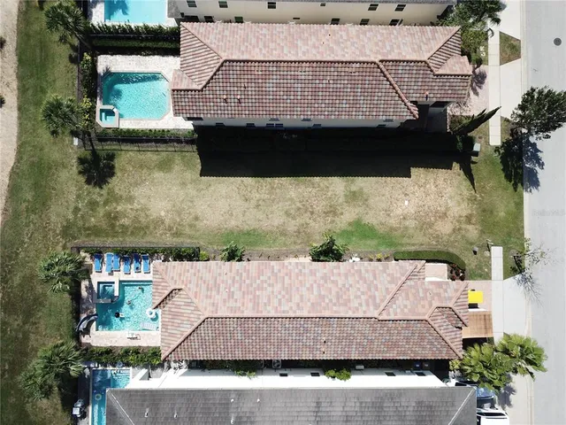 an aerial view of a house with a yard