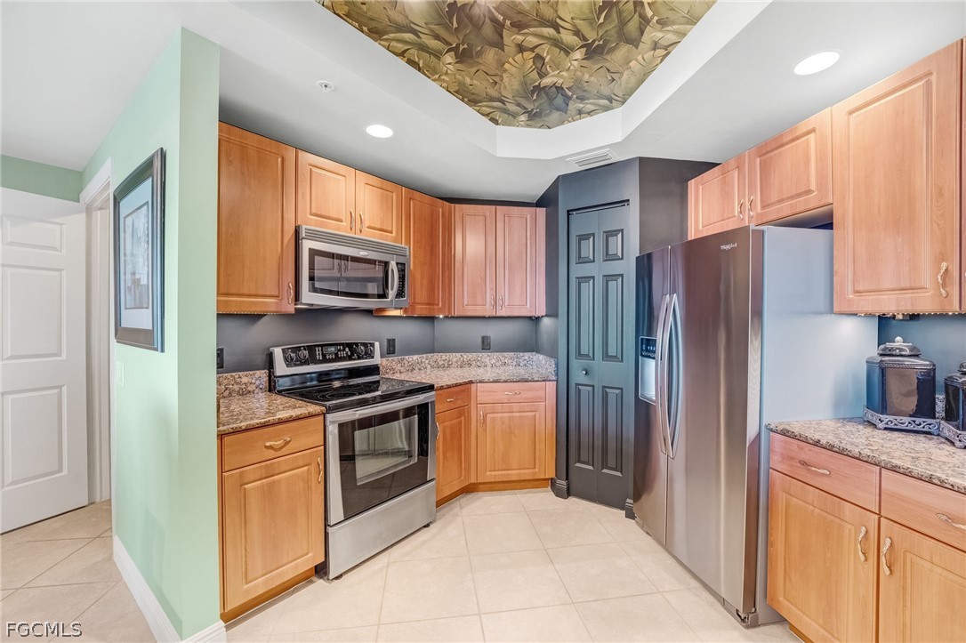2743 First Street, Unit 2102 Fort Myers, FL 33916 - Photo 14 of 42 a kitchen with stainless steel appliances granite countertop a refrigerator stove and sink