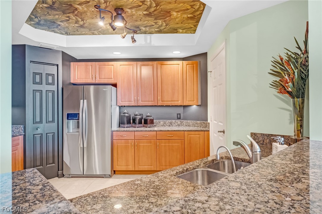 2743 First Street, Unit 2102 Fort Myers, FL 33916 - Photo 15 of 42 a kitchen with stainless steel appliances granite countertop a refrigerator and a sink