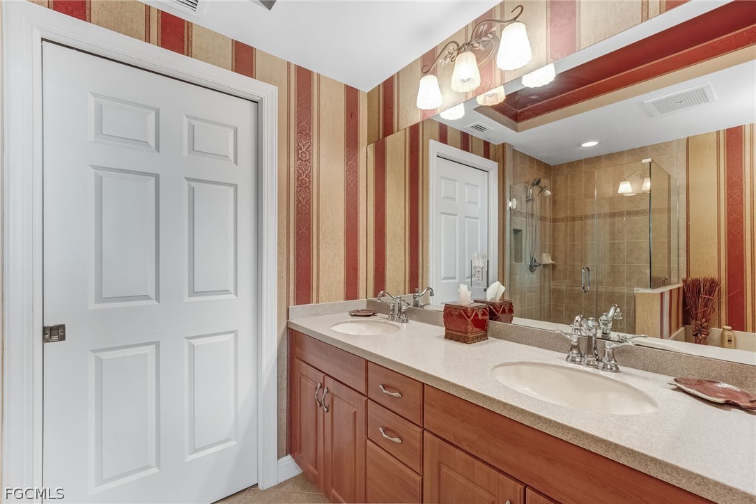 2743 First Street, Unit 2102 Fort Myers, FL 33916 - Photo 22 of 42 a bathroom with double vanity sinks a vanity and a mirror