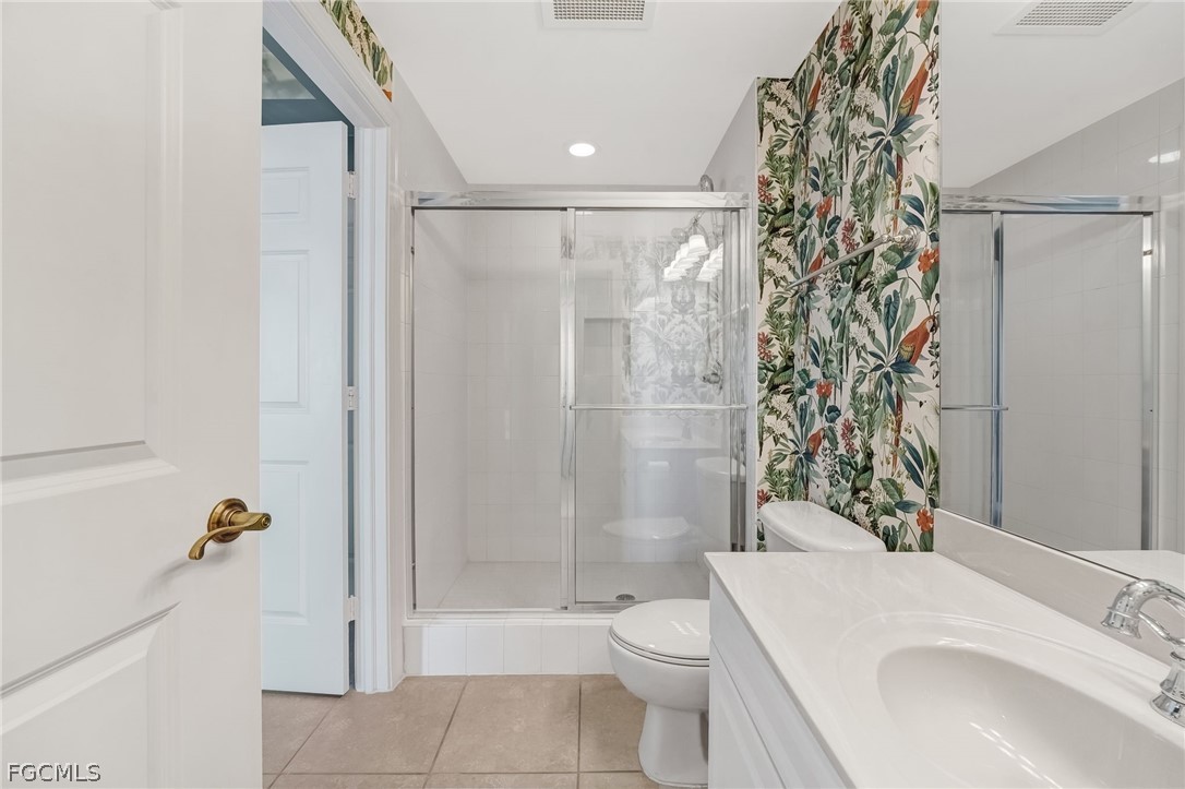 2743 First Street, Unit 2102 Fort Myers, FL 33916 - Photo 29 of 42 a bathroom with a sink a toilet and shower