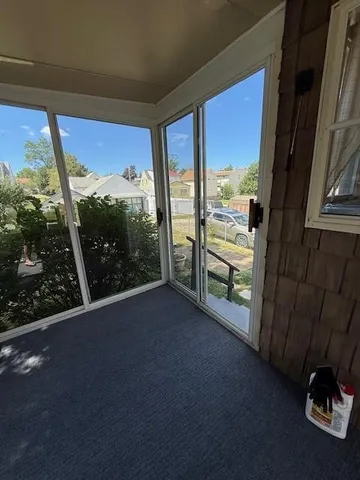 a view of a floor to ceiling window next to a yard