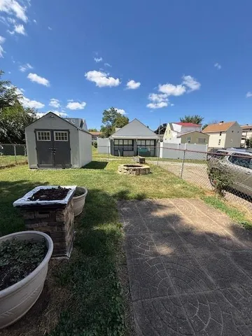 a view of a house with backyard and sitting area