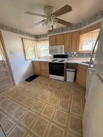 a kitchen with stainless steel appliances a sink stove and window
