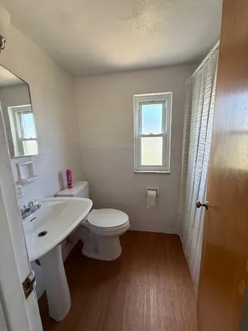 a bathroom with a sink toilet and a mirror