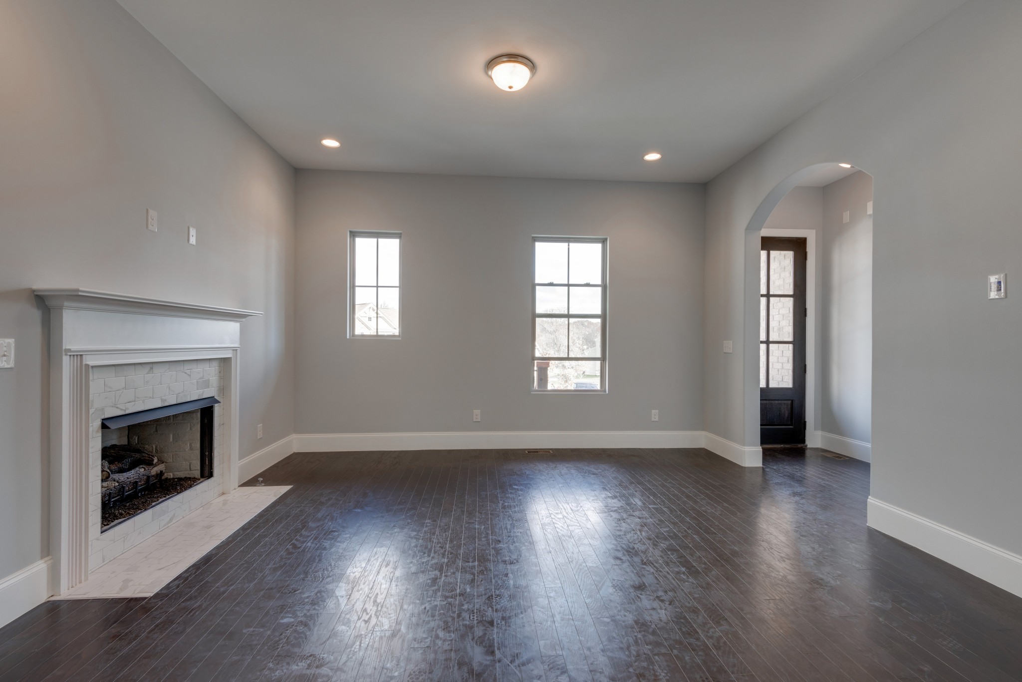 18 Hon Circle Murfreesboro, TN 37128 - Photo 7 of 30 an empty room with wooden floor fireplace and windows