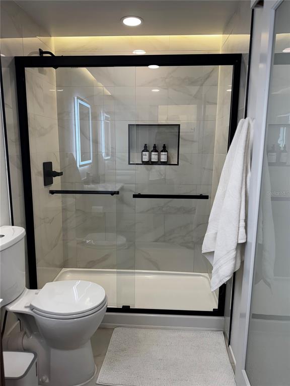 43420 Highway 27, Unit 414 Davenport, FL 33837 - Photo 26 of 41 a bathroom with a toilet and a shower