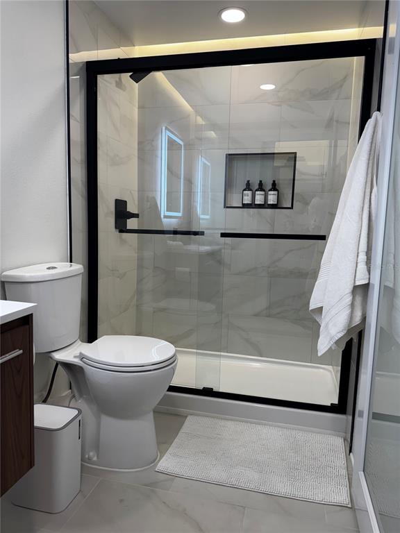 43420 Highway 27, Unit 414 Davenport, FL 33837 - Photo 27 of 41 a bathroom with a toilet and a shower