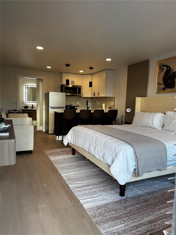 43420 Highway 27, Unit 414 Davenport, FL 33837 - Photo 30 of 41 a spacious bedroom with a bed a couch and a television