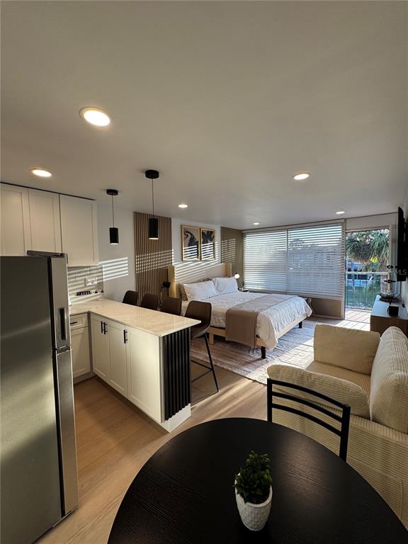 43420 Highway 27, Unit 414 Davenport, FL 33837 - Photo 37 of 41 a living room with furniture kitchen view and a refrigerator