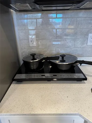 a kitchen with stainless steel appliances granite countertop a sink and a microwave