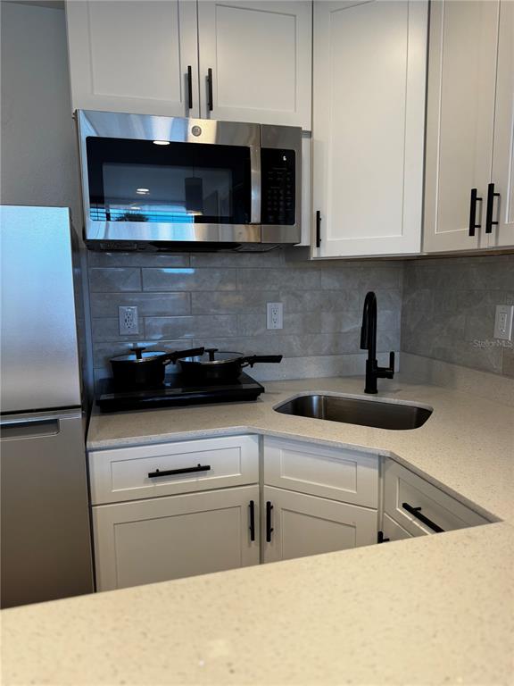 43420 Highway 27, Unit 414 Davenport, FL 33837 - Photo 6 of 41 a kitchen with stainless steel appliances granite countertop a sink and a microwave