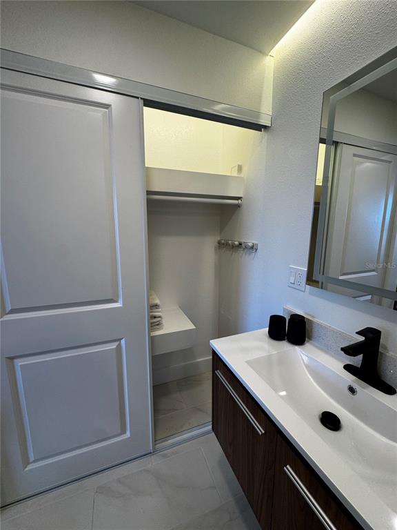 43420 Highway 27, Unit 414 Davenport, FL 33837 - Photo 9 of 41 a kitchen with a sink and white cabinets