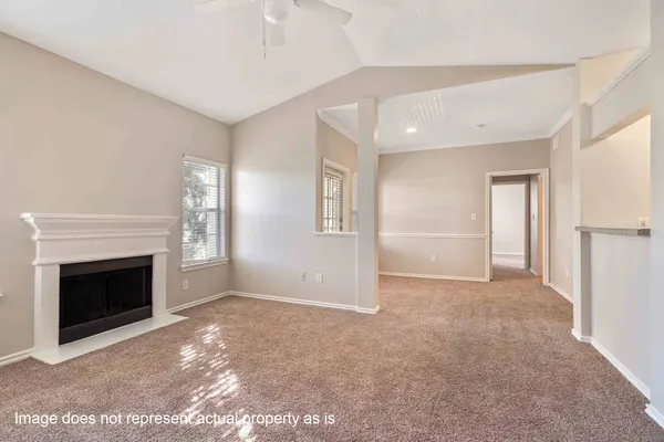 a view of empty room with a fireplace