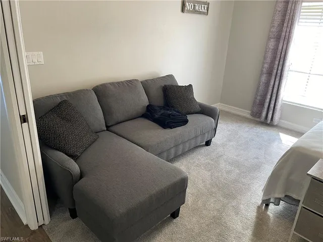 a view of room with window and mirror