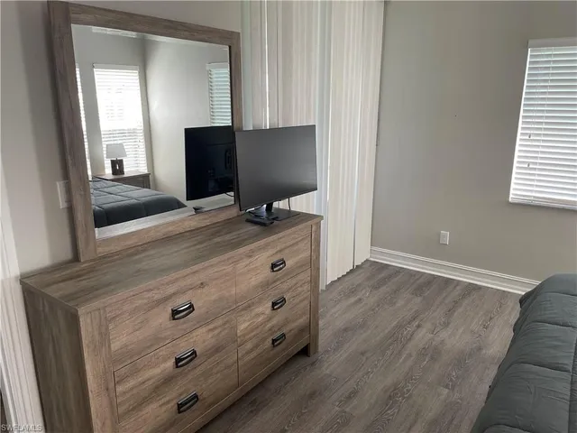 a bedroom with a bed and a mirror