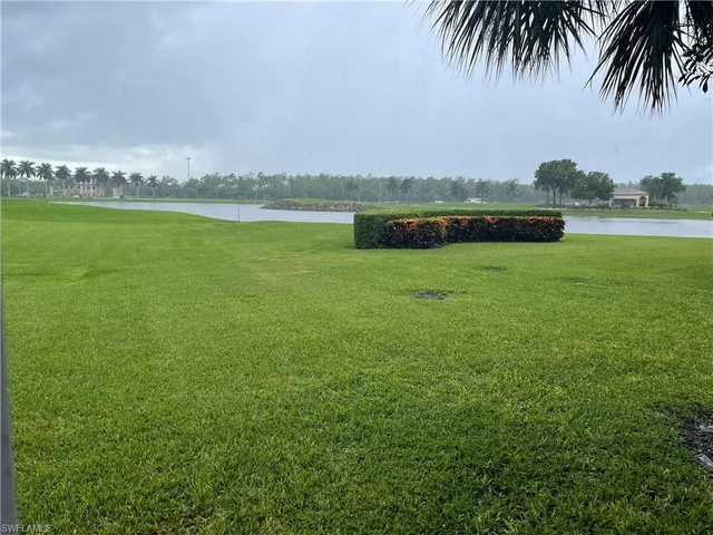 a view of a lake with houses in the back