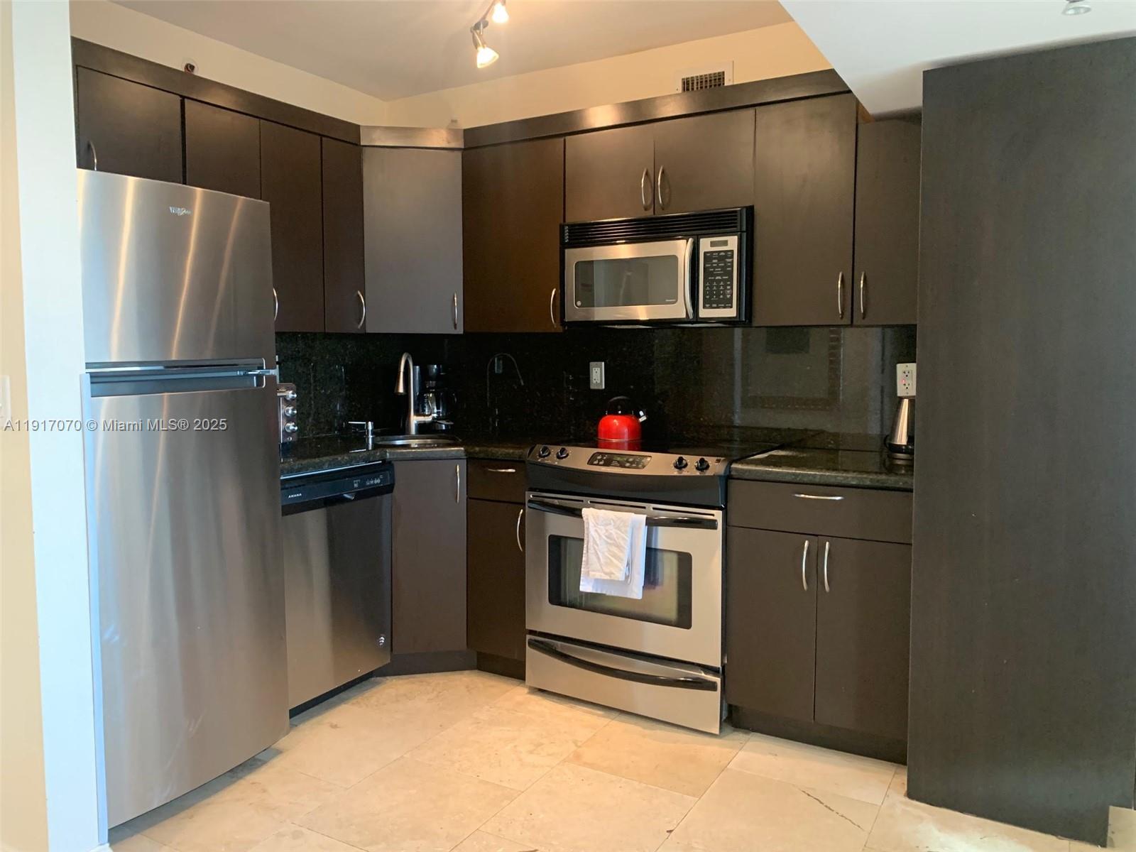 100 Lincoln Road, Unit 1122 Miami Beach, FL 33139 - Photo 12 of 29 a kitchen with a refrigerator and a sink