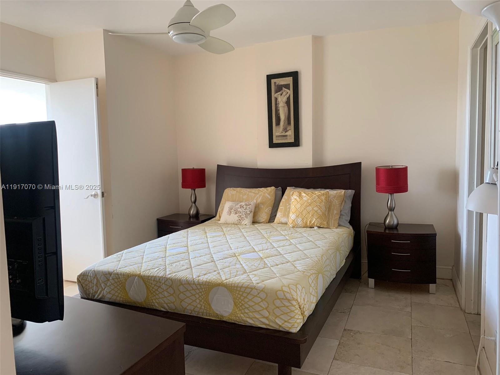 100 Lincoln Road, Unit 1122 Miami Beach, FL 33139 - Photo 14 of 29 a bedroom with a bed and a potted plant