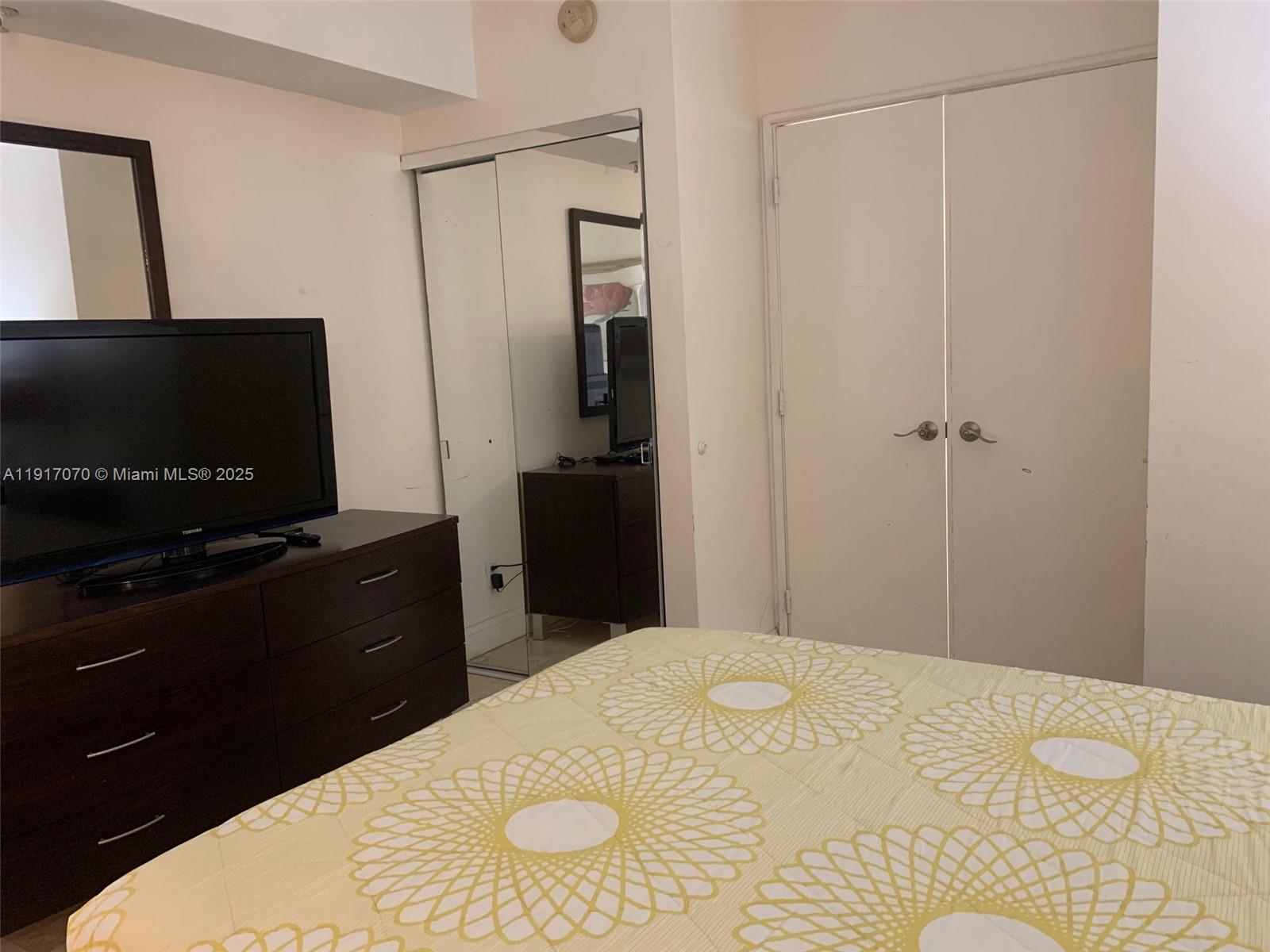 100 Lincoln Road, Unit 1122 Miami Beach, FL 33139 - Photo 20 of 29 a bedroom with a bed and a flat screen tv