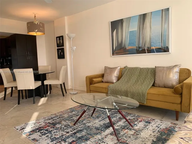 a living room with furniture and a rug