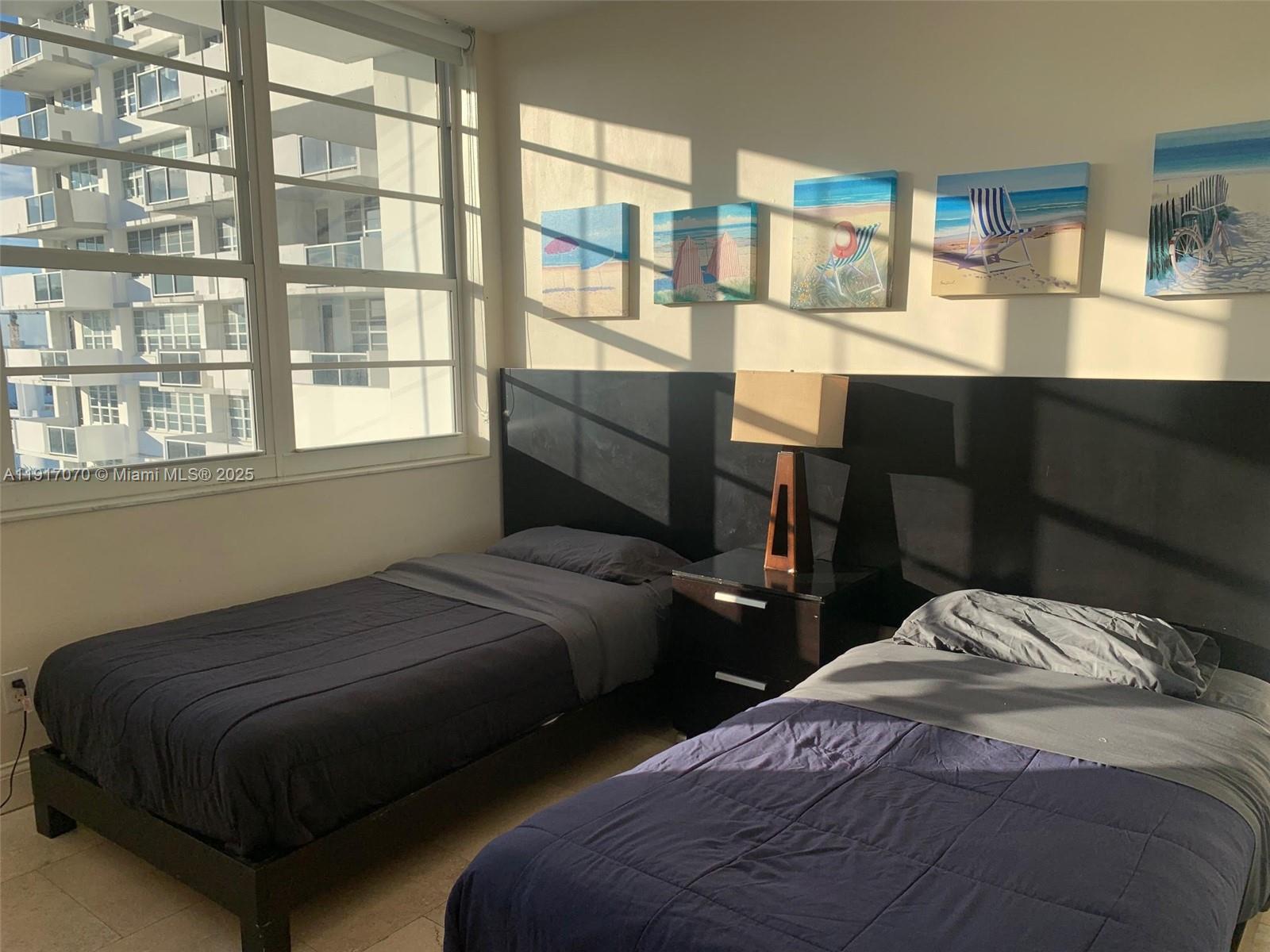 100 Lincoln Road, Unit 1122 Miami Beach, FL 33139 - Photo 22 of 29 a bedroom with two beds and a window