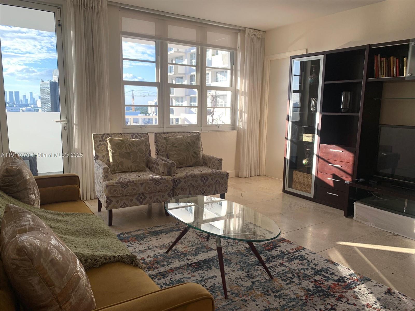 100 Lincoln Road, Unit 1122 Miami Beach, FL 33139 - Photo 5 of 29 a living room with furniture and a window