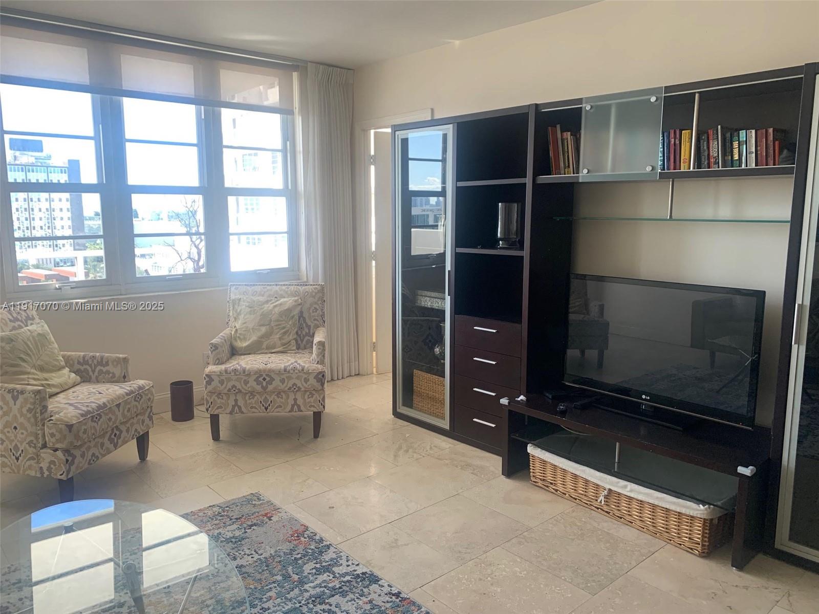 100 Lincoln Road, Unit 1122 Miami Beach, FL 33139 - Photo 10 of 29 a living room with furniture and a flat screen tv