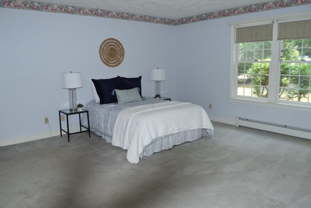 111 Bear Hill Road North Andover, MA 01845 - Photo 17 of 41 a bed sitting in a bedroom next to a window