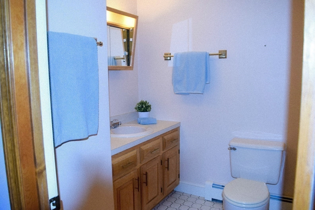 111 Bear Hill Road North Andover, MA 01845 - Photo 31 of 41 a bathroom with a granite countertop sink toilet and mirror