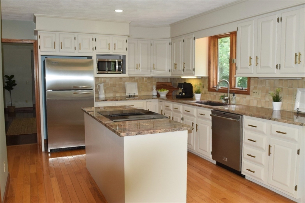 111 Bear Hill Road North Andover, MA 01845 - Photo 7 of 41 a kitchen with granite countertop a refrigerator sink and cabinets