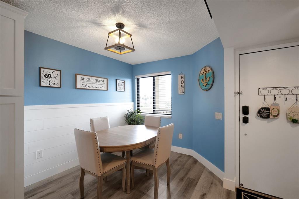 6035 Sea Ranch Drive, Unit 215 Hudson, FL 34667 - Photo 11 of 76 a view of a dining room with furniture and chandelier