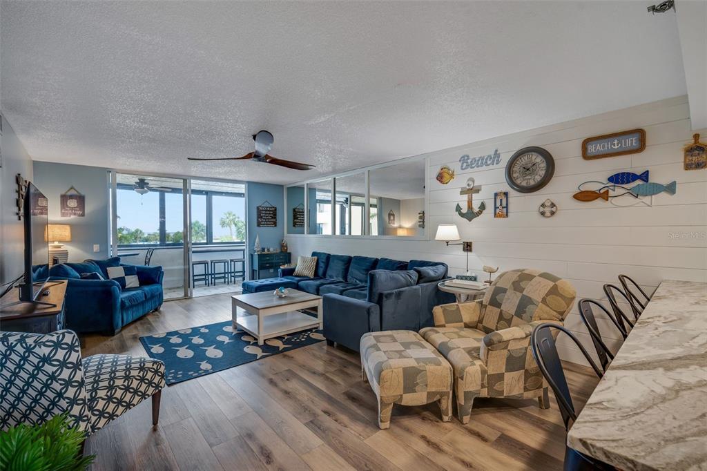 6035 Sea Ranch Drive, Unit 215 Hudson, FL 34667 - Photo 12 of 76 a living room with furniture and wooden floor