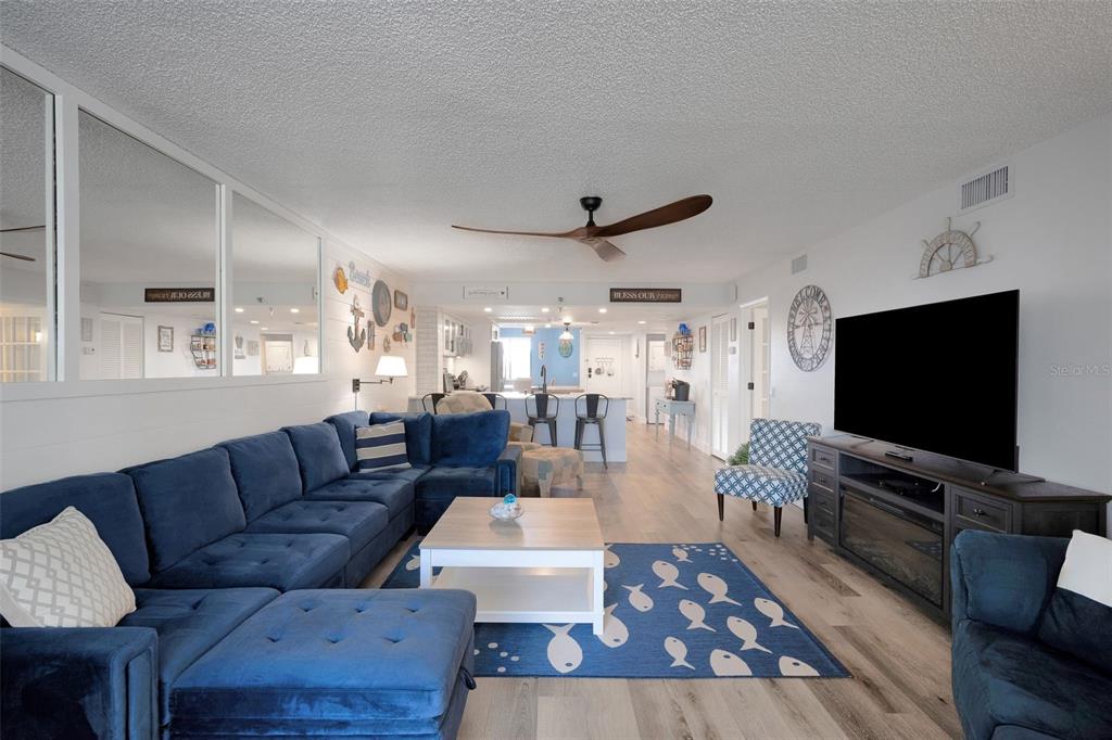 6035 Sea Ranch Drive, Unit 215 Hudson, FL 34667 - Photo 13 of 76 a living room with furniture and a flat screen tv