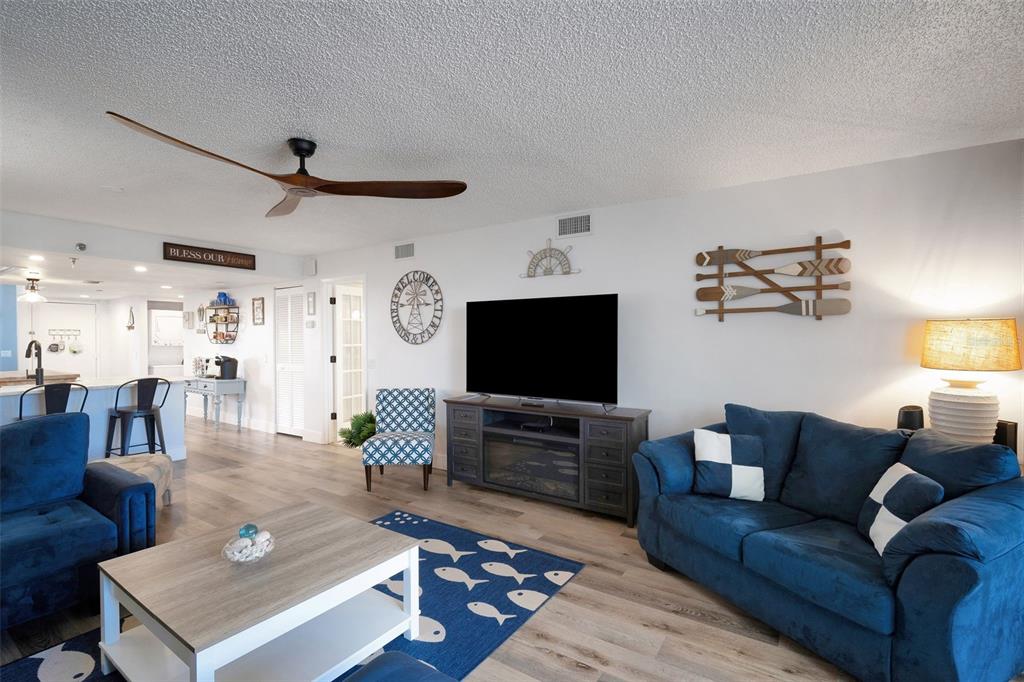 6035 Sea Ranch Drive, Unit 215 Hudson, FL 34667 - Photo 14 of 76 a living room with furniture and a flat screen tv