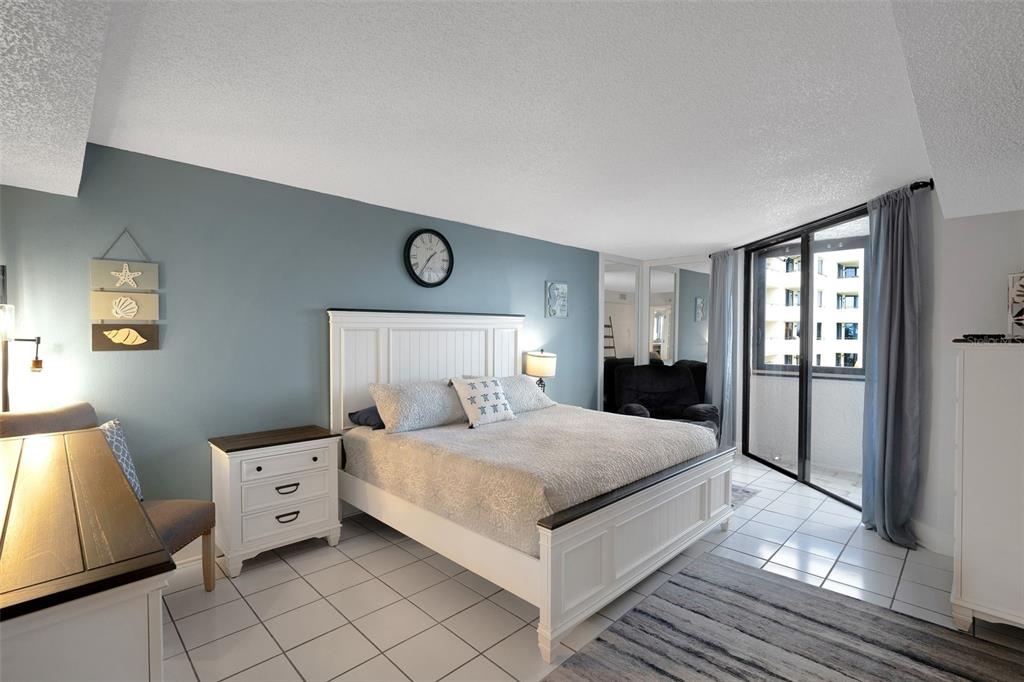 6035 Sea Ranch Drive, Unit 215 Hudson, FL 34667 - Photo 16 of 76 a bedroom with a large bed and a window