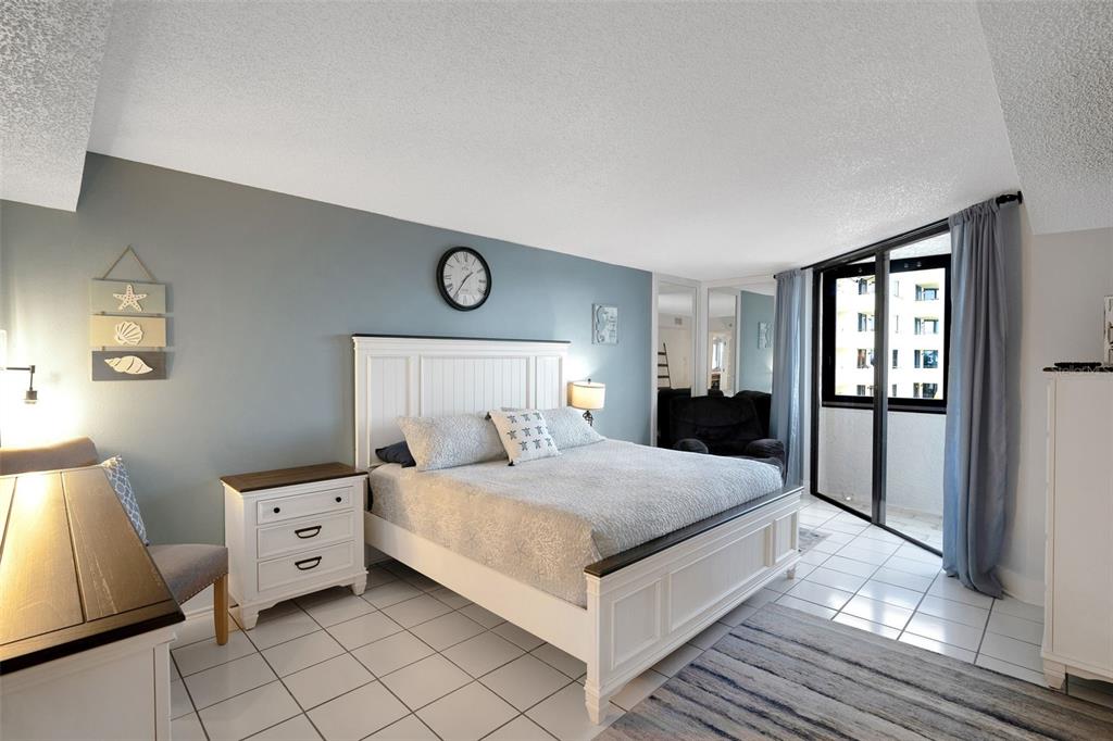 6035 Sea Ranch Drive, Unit 215 Hudson, FL 34667 - Photo 23 of 76 a bedroom with a bed and a window